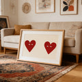 Framed heart couple poster leaning beside a neutral sofa