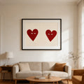 Red heart couple print above a sofa in a bright living room