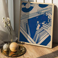 Framed blue music map poster leaning on wood floor