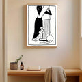 Embracing couple and cat artwork displayed above a minimalist desk alcove