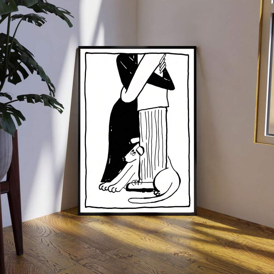 Black-framed couple and cat line art leaning beside a large green plant