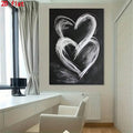 Black and white heart poster hanging over bright minimalist home office