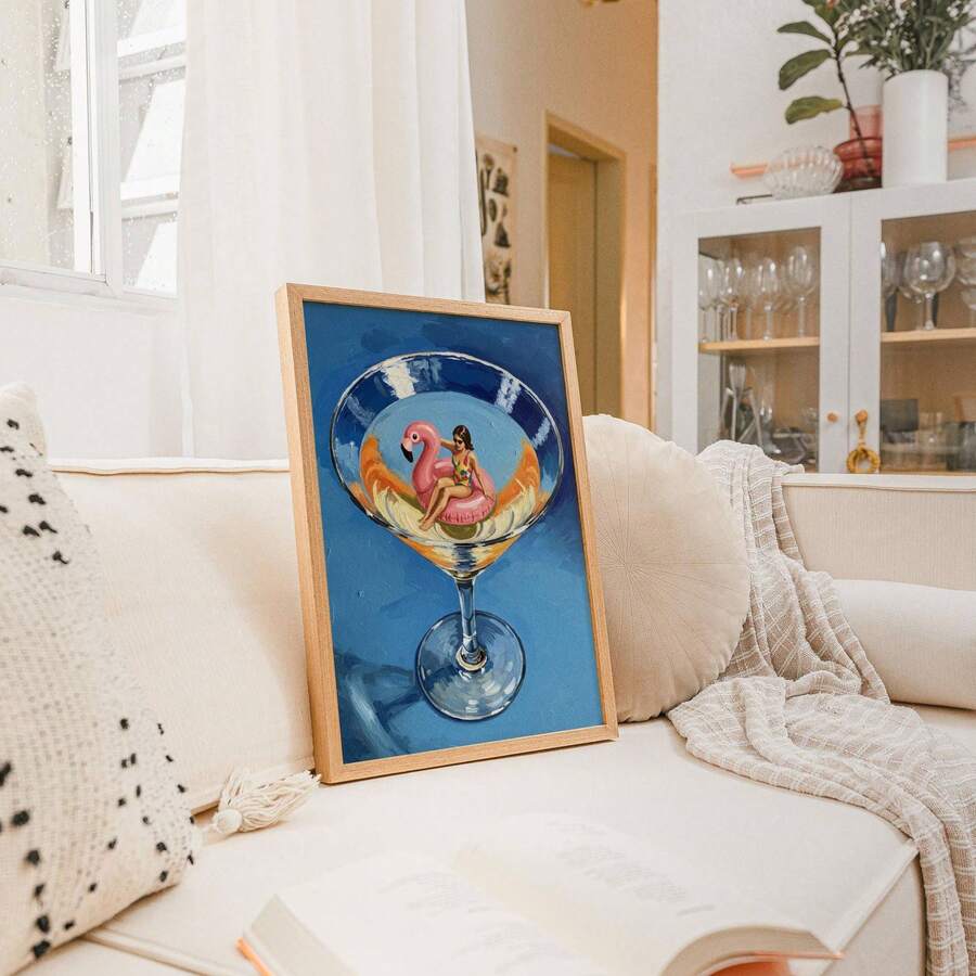 Blue cocktail poster with flamingo float and swimmer in a framed display