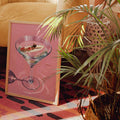 Pink martini canvas poster with a floating swimmer beside houseplants