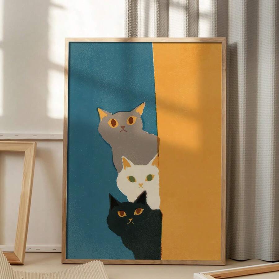 Three stacked cats in teal and mustard wall art beside a modern bedroom desk