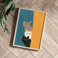 Teal and mustard stacked kitten artwork styled on a herringbone wood floor