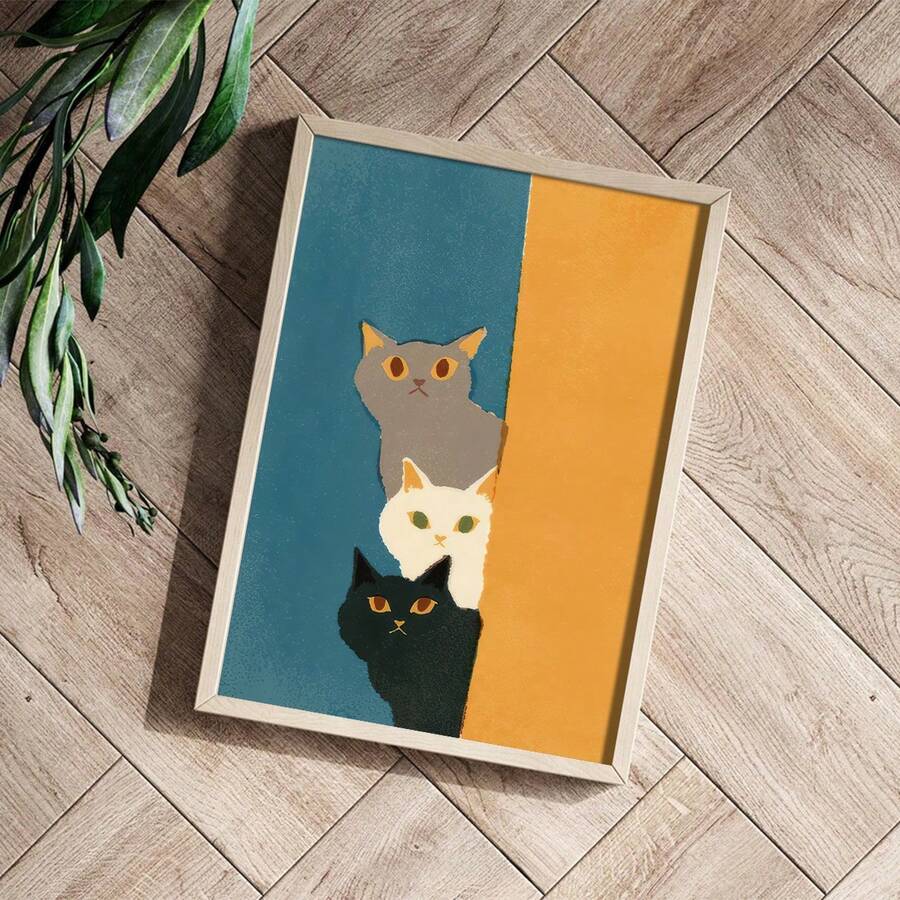 Teal and mustard stacked kitten artwork styled on a herringbone wood floor