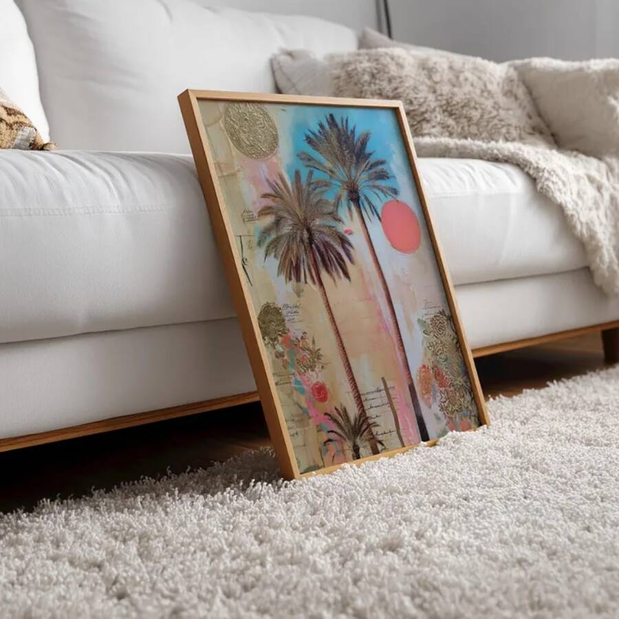 Framed palm tree canvas print leaning beside a pale sofa in a cozy living room