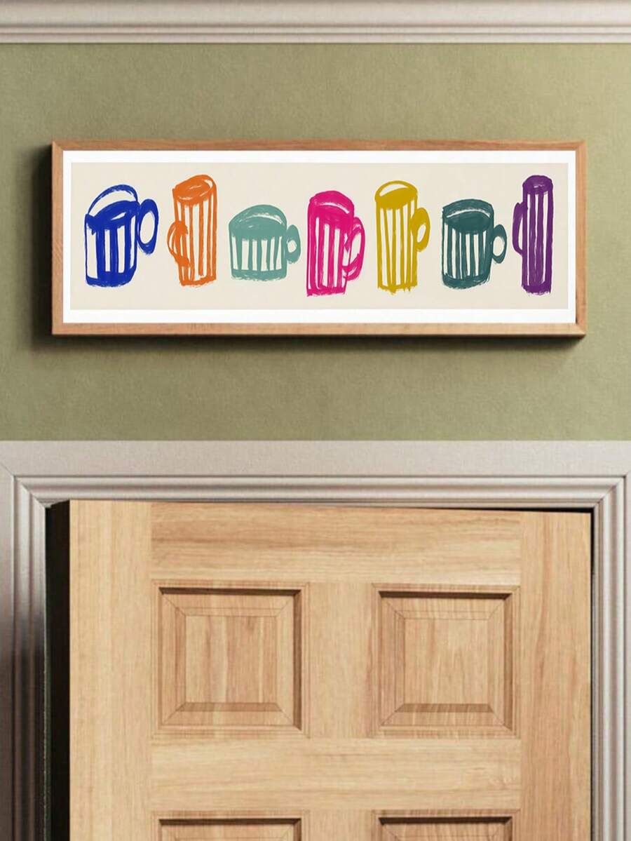 Coffee mug wall art shown above a modern kitchen counter