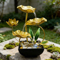 Outdoor garden view of gold lotus tabletop fountain with flowing water.