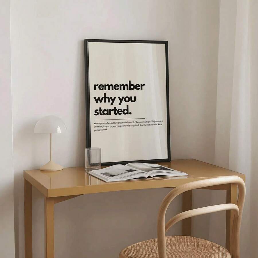 Black frame display of positive affirmation wall art on a minimalist study desk