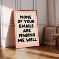 Warm wood frame display of pink workplace humor poster on herringbone floor