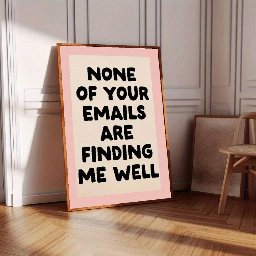 Warm wood frame display of pink workplace humor poster on herringbone floor