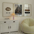Three gold-framed Scandinavian magazine prints above a white cabinet with a green chair