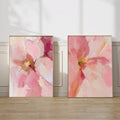 Pink abstract floral canvas pair displayed in a bright neutral room