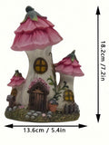 Close view of resin mushroom house figurine with yellow windows and painted woodland texture
