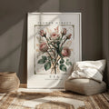 Rose flower market canvas print styled beside a woven pouf and neutral linens