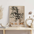 Neutral farmhouse citrus and flower art displayed above a console table