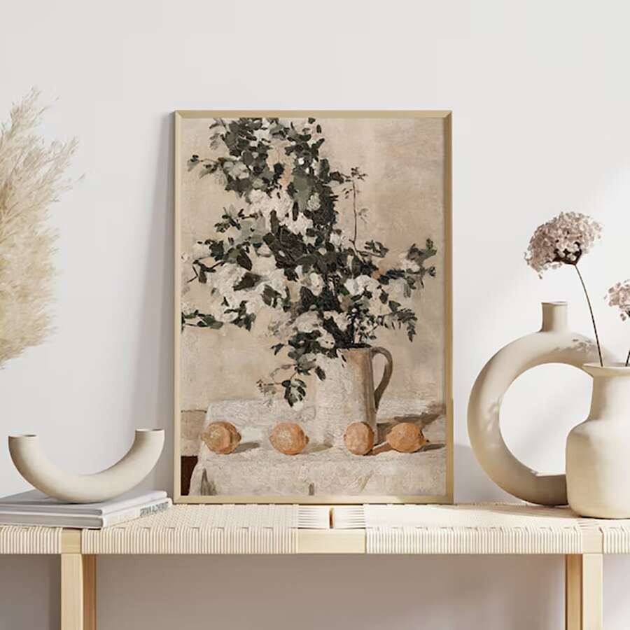 Neutral farmhouse citrus and flower art displayed above a console table