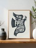 Peace dove freedom quote poster reading We Are Not Free Until Everyone Is Free on shelf