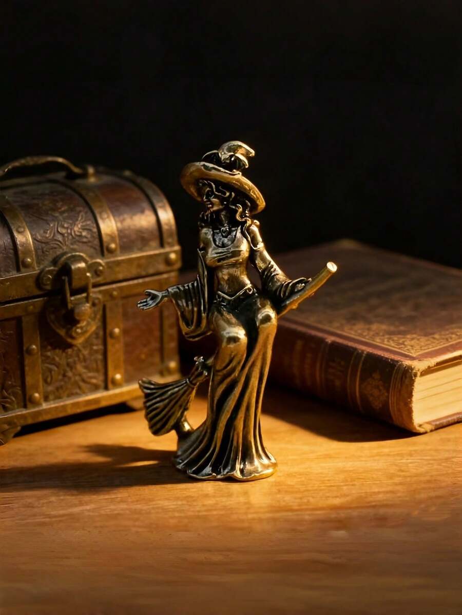 Vintage brass witch broom figurine with pointed hat