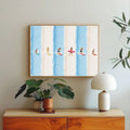 Blue striped surfer artwork above a light wood console and houseplants