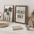 Palm tree and Locals Only prints styled with woven baskets and neutral decor