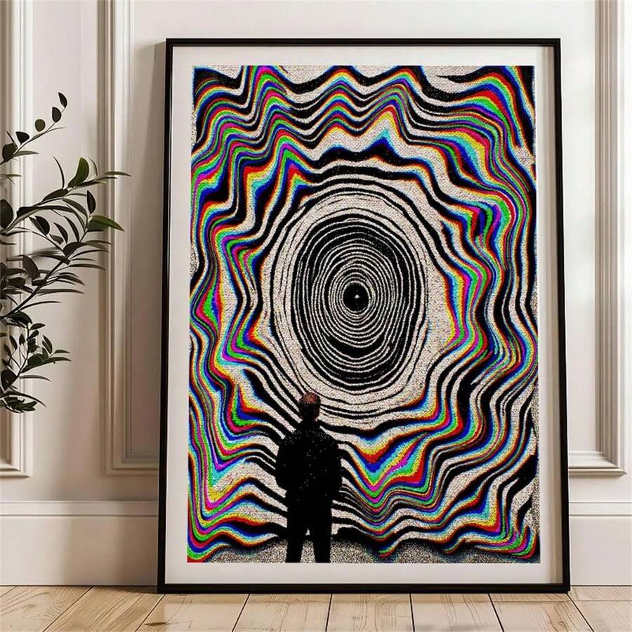 Black-framed optical illusion poster displayed beside a leafy indoor plant