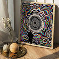 Light wood framed vortex canvas styled on a console with flowers and neutral decor