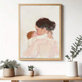 Framed mother and baby family wall art above a light wood console with plants