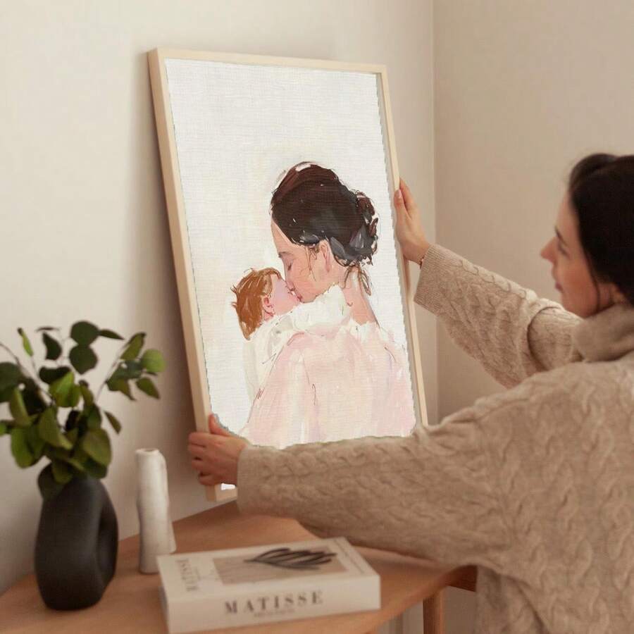 Watercolor mother and baby canvas poster in a gold frame against a paneled wall