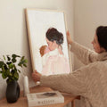 Mother and baby watercolor canvas poster being placed in a warm neutral room