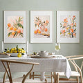 Styled display of vintage floral canvas wall art for a warm dining room