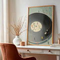 Framed dancing figures record artwork styled beside a terracotta chair