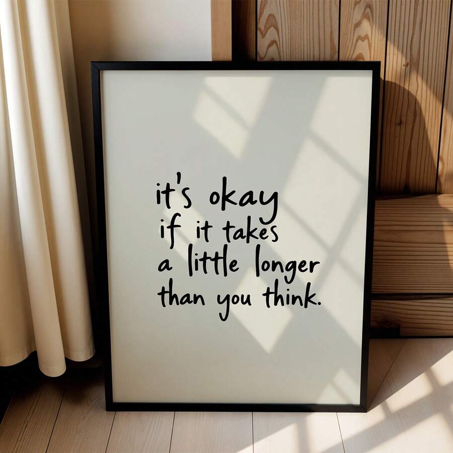 Black framed inspirational quote poster beside curtains and wood paneling