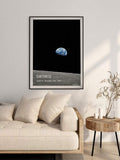 Framed Earthrise canvas poster displayed beside a cream living room sofa