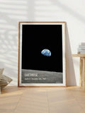 Earthrise Apollo 8 canvas shown in a light wood frame beside a table