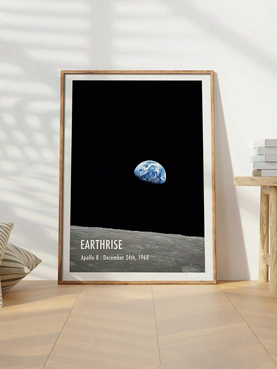 Earthrise Apollo 8 canvas shown in a light wood frame beside a table
