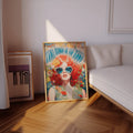 Framed hippie floral woman poster beside a modern sofa