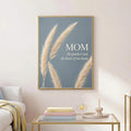 Charcoal-framed pampas grass Mom canvas displayed on an ivory wall above a styled console
