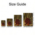Framed cherry fruit painting displayed beside a wooden cutting board and leafy plant