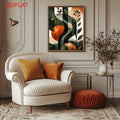 Earthy green and rust abstract leaf canvas above a cream living-room chair