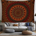 Rust orange mandala tapestry above white sofa