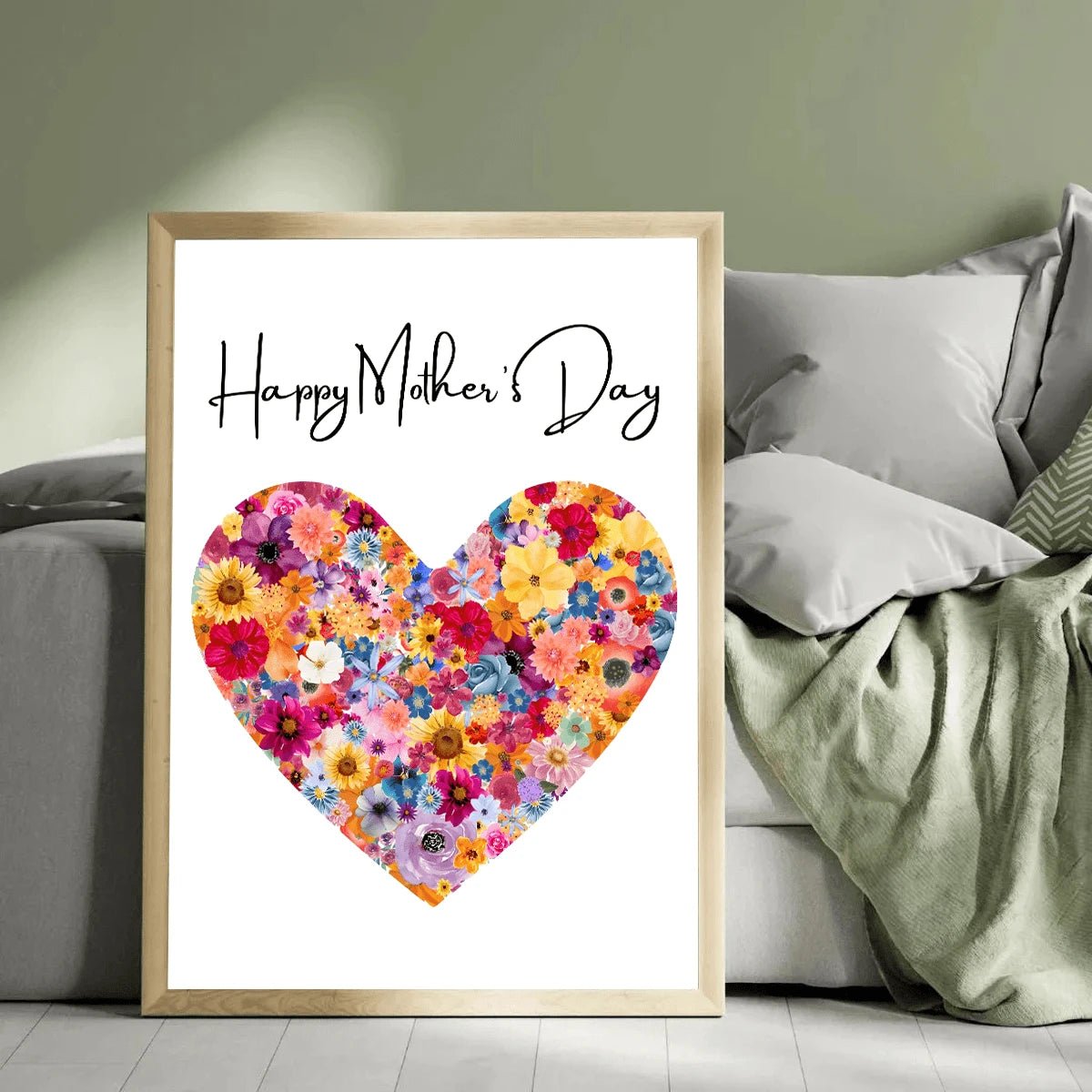 Framed floral heart canvas poster beside a bed with green bedding