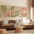 Pink and mustard floral canvas artwork displayed as three framed panels above a brown sofa with striped cushions