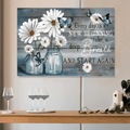 Rustic daisy and butterfly quote artwork on a blue-gray plank background above a dining console with wine glasses