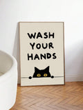 Framed black cat handwashing poster leaning beside a white bathtub