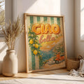 Light wood framed Ciao Bella coastal art styled beside ceramic vase and woven basket in a bright room