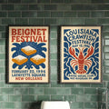 Framed beignet and crawfish festival prints mounted on a dark green tiled kitchen wall
