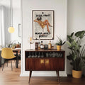 Framed martini party canvas displayed above a home bar cabinet